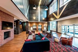 a living room with a couch and a fireplace at Four Points By Sheraton Houston Energy Corridor in Katy
