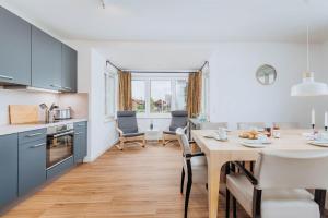 a kitchen and dining room with a table and chairs at Zur Oie 27 in Bresewitz