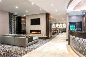 a lobby with a couch and a fireplace at Fairfield Inn & Suites by Marriott Boston Cambridge in Cambridge