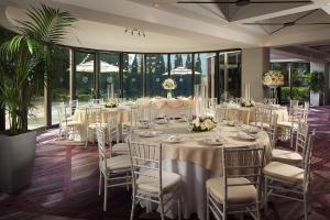 a banquet room with tables and chairs with white tablecloths at Sheraton Gateway Los Angeles Hotel in Los Angeles