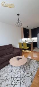 a living room with a couch and a table at Apartman Stevanovic BN in Bijeljina