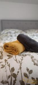 a blanket and a towel on a bed at Apartman Stevanovic BN in Bijeljina
