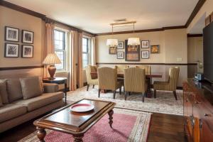 a living room with a couch and a dining room table at Sheraton Commander Hotel in Cambridge