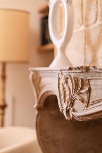 a white vase with a mirror on top of it at Sella&Mosca Casa Villamarina in Alghero