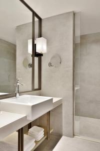 a bathroom with a sink and a shower at Courtyard by Marriott Siliguri in Siliguri