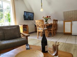 a living room with a bottle of wine on a table at Ferienwohnung "Neptun" im Haus Tjark in Sankt Peter-Ording