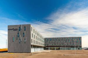 a building with a sign on the side of it at Courtyard by Marriott Reykjavik Keflavik Airport in Keflavík