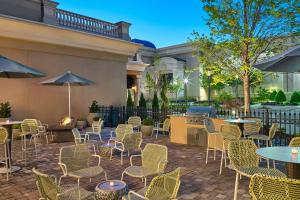 a patio with tables and chairs and a grill at Element Huntsville in Huntsville