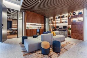 a living room with a couch and a table at Courtyard by Marriott Reykjavik Keflavik Airport in Keflavík