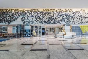 a lobby with a large mural on the wall at Le Meridien Dhaka in Dhaka