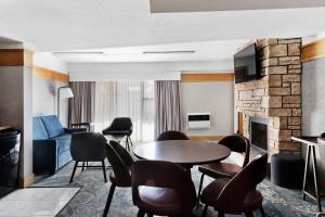 a living room with a table and chairs and a fireplace at Four Points by Sheraton Ventura Harbor Resort in Ventura