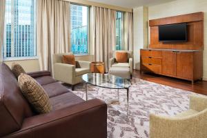 a living room with a couch and a television at The Westin Minneapolis in Minneapolis