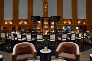 a bar in a restaurant with chairs and tables at The Westin Minneapolis in Minneapolis