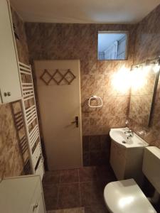 a bathroom with a white toilet and a sink at Sonja Apartment in Premantura +17 photos