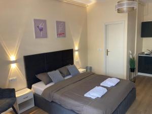 a bedroom with a large bed with two towels on it at STUDIOAPARTMANI JEDVAJ in Krapina