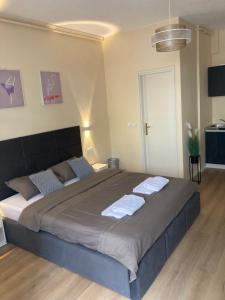 a bedroom with a large bed with towels on it at STUDIOAPARTMANI JEDVAJ in Krapina