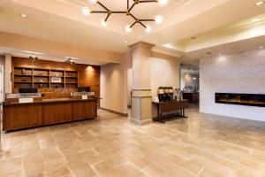 a hotel lobby with a reception desk and a fireplace at Four Points by Sheraton St. Louis - Fairview Heights in Fairview Heights