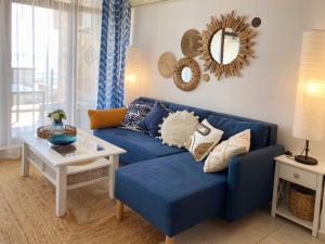 a living room with a blue couch and a table at Dolce Vita Blue Boho, Premium Apartment with seaview in Sveti Vlas