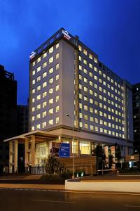 a hotel building with a lit up facade at night at Fairfield by Marriott Lucknow in Lucknow