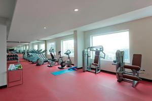 a gym with rows of treadmills and elliptical machines at Fairfield by Marriott Lucknow in Lucknow