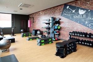 a fitness room with a brick wall and a gym at Moxy Rust in Rust