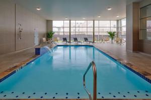 a large pool with blue water in a hotel room at Four Points by Sheraton Houston Intercontinental Airport in Houston