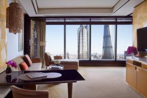 a living room with a view of a city at The Ritz-Carlton Shanghai, Pudong in Shanghai
