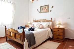 een slaapkamer met een groot bed met een houten frame bij Casa Canaria Vistas al Mar in Santa Cruz de la Palma