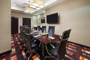 a conference room with a long table and black chairs at Courtyard by Marriott Times Square West in New York