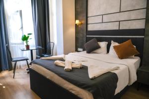 a bedroom with a large bed with towels on it at La Pazza Suites in Istanbul