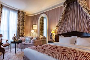 a hotel room with a bed and a living room at Le Dokhan's Paris Arc de Triomphe, a Tribute Portfolio Hotel in Paris