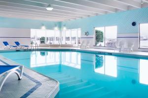 a swimming pool with blue walls and windows at Delta Hotels by Marriott Sault Ste. Marie Waterfront in Sault Ste. Marie