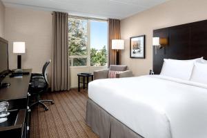 a hotel room with a large bed and a desk at Delta Hotels by Marriott Sault Ste. Marie Waterfront in Sault Ste. Marie