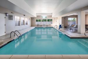 a large swimming pool with blue water in a building at Residence Inn by Marriott Boulder Broomfield in Louisville