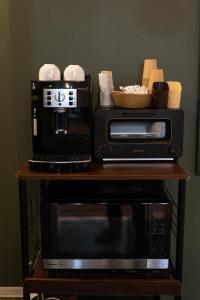 a microwave and a coffee maker on a table at azamianassobo in Asso
