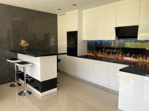 a kitchen with a counter with a fireplace at Domki u Ewy in Stronie Śląskie