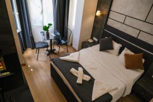 a teddy bear sitting on a bed in a room at La Pazza Suites in Istanbul