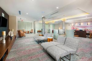 a large lobby with couches and a waiting room at Courtyard by Marriott Santa Ana Orange County in Santa Ana