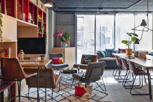 un bureau avec des chaises et un bureau avec un ordinateur dans l'établissement Moxy Paris Bastille, à Paris