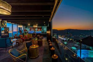 a restaurant with a view of the city at night at W Santiago in Santiago