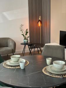 a living room with a table with bowls on it at Hotel De Lange Akker in Berg en Terblijt