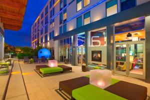a building with couches and chairs in a courtyard at Aloft Portland Airport Hotel at Cascade Station in Portland