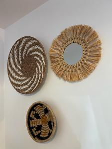 two baskets and a mirror on a white table at Hotel De Lange Akker in Berg en Terblijt