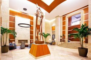 a lobby with a statue and plants in it at The Westin Alexandria Old Town in Alexandria