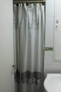 a bathroom with a shower curtain with a face on it at Monoambiente microcentro in Bahía Blanca
