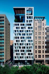 a tall building with balconies on the side of it at Aloft Taipei Zhongshan in Taipei