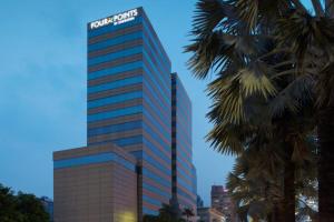 a tall building with a sign on top of it at Four Points by Sheraton Jakarta Thamrin in Jakarta