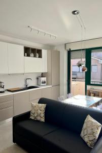 a living room with a couch and a kitchen at Maison Chic Montenero Marina in Marina di Montenero