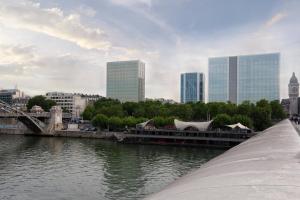 a bridge over a river with a city in the background at Courtyard by Marriott Paris Gare de Lyon in Paris