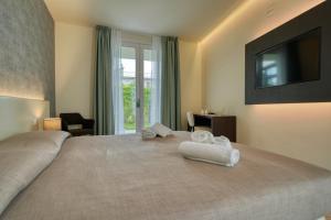 Posteľ alebo postele v izbe v ubytovaní Hotel Palazzo del Garda & Spa